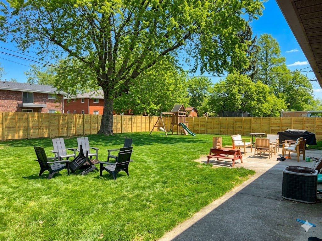 Backyard with wood privacy fence, patio, and firepit seating in a Dayton-area home